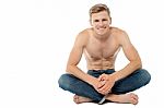 Shirtless Man Sitting On The Floor Stock Photo