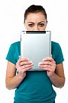 Shy Pretty Model Hiding Face With Tablet Pc Stock Photo