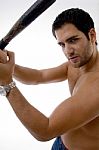 Side Pose Of Man With Stick Stock Photo