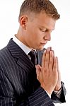 Side Pose Of Praying Businessman Stock Photo