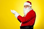 Side Profile Of Santa Facing Camera With Open Palms Stock Photo