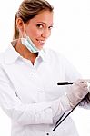 Side View Of Smiling Doctor With Writing Pad Stock Photo