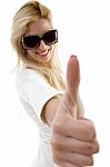 Side View Of Smiling Woman Showing Thumbs Up Stock Photo