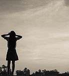 Silhouette Of Woman Praying Over Beautiful Sky Background Stock Photo