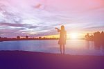 Silhouette Of Woman Praying Over Beautiful Sky Background Stock Photo