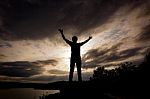 Silhouette Tourist Man Open Arm. He Is Happy In The Mountain. To Stock Photo