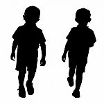 Silhouettes Of Two Little Boys Stock Photo