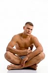 Sitting Muscular Guy With Chocolate Stock Photo