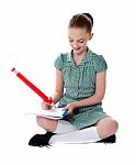 Sitting Schoolgirl Doing Homework Stock Photo