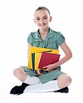 Sitting Schoolgirl Holding Books Stock Photo