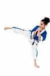 Small Kid Practicing Karate Kick Stock Photo