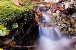 Small Waterfall In Autumn Forest Stock Photo