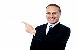 Smart Businessman Pointing Away Stock Photo