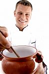 Smart Chef Cooking In Porcelain Pot Stock Photo