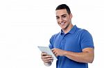 Smart Guy Browsing On His Tablet Device Stock Photo