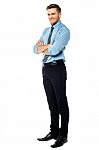 Smart Smiling Businessman With Arms Crossed Stock Photo