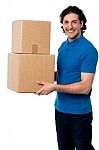 Smart Young Man Carrying Boxes Stock Photo