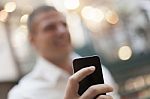 Smartphone In Hand Of Businessman Stock Photo