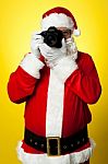 Smile Please! Santa Capturing A Perfect Frame Stock Photo