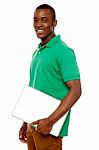 Smiling African Guy Carrying Laptop Stock Photo