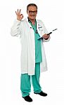 Smiling Aged Doctor With Ok Gesture Stock Photo