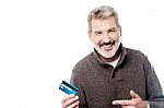 Smiling Aged Man Showing His Debit Card Stock Photo