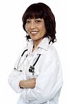 Smiling Asian Doctor Arms Crossed Stock Photo