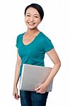 Smiling Asian Female Posing With Laptop Stock Photo