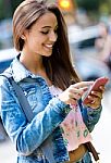 Smiling Beautiful Woman Texting With Her Phone Stock Photo