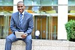 Smiling Business Executive Using Tablet Stock Photo