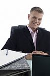 smiling Businessman At Desk Stock Photo