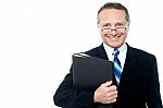 Smiling Businessman Holding File Folders Stock Photo