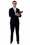 Smiling Businessman Holding Folder Stock Photo