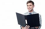 Smiling Businessman Holding The Folder Stock Photo