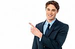 Smiling Businessman Pointing Away Stock Photo