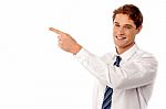 Smiling Businessman Pointing Away Stock Photo