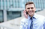 Smiling Businessman Talking On The Phone Stock Photo