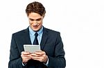 Smiling Businessman Using A Tablet Pc Stock Photo