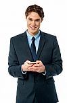 Smiling Businessman Using Mobile Phone Stock Photo