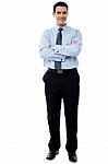 Smiling Businessman With Arms Crossed Stock Photo