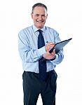 Smiling Businessman With Clipboard Stock Photo