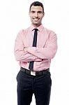 Smiling Businessman With Crossed Arms Stock Photo