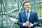 Smiling Businessman With Cup Of A Coffee Stock Photo