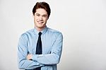 Smiling Businessman With Folded Arms Stock Photo