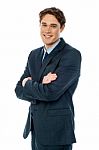 Smiling Businessman With Folded Arms Stock Photo