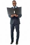 Smiling Businessman With Folder Stock Photo