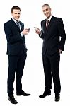 Smiling Businessmen Using Cellphone Stock Photo