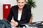 Smiling Businesswoman At Her Work Desk Stock Photo