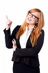 Smiling Businesswoman Pointing Upwards Stock Photo