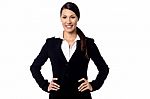 Smiling Businesswoman With Hands On Hips Stock Photo